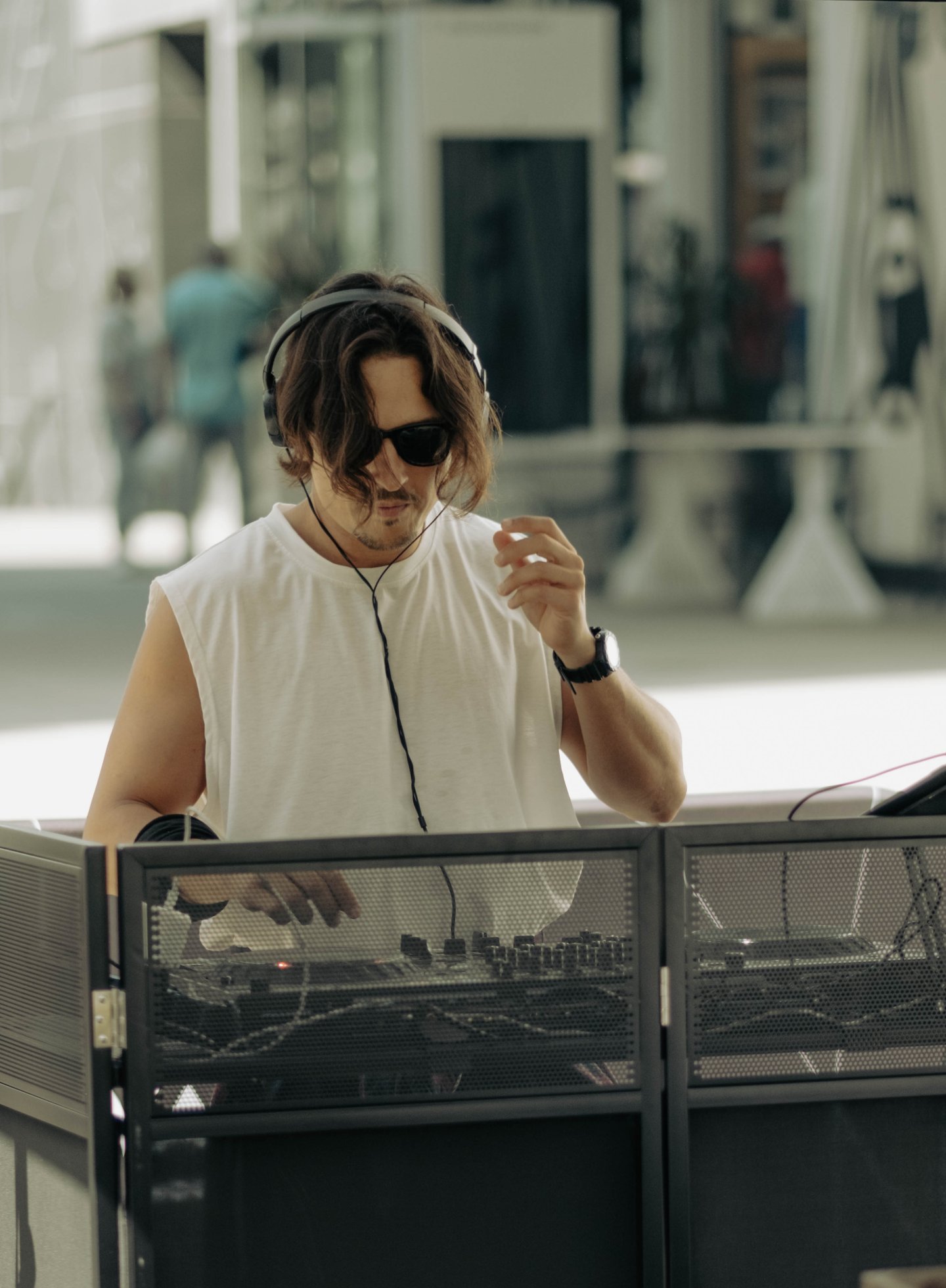 Vento wearing headphones and DJing at an outdoor event